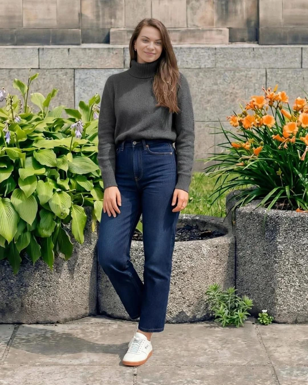 A charcoal turtleneck with dark straight-leg jeans and white sneakers
