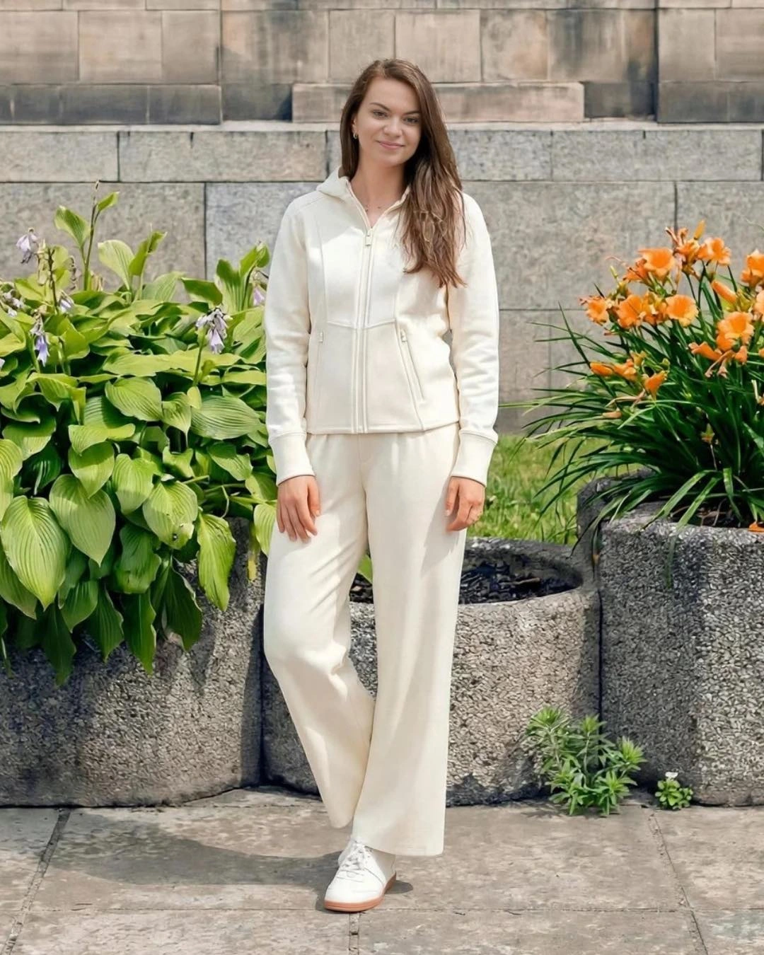 A cream zip jacket with cream wide-leg trousers and white sneakers