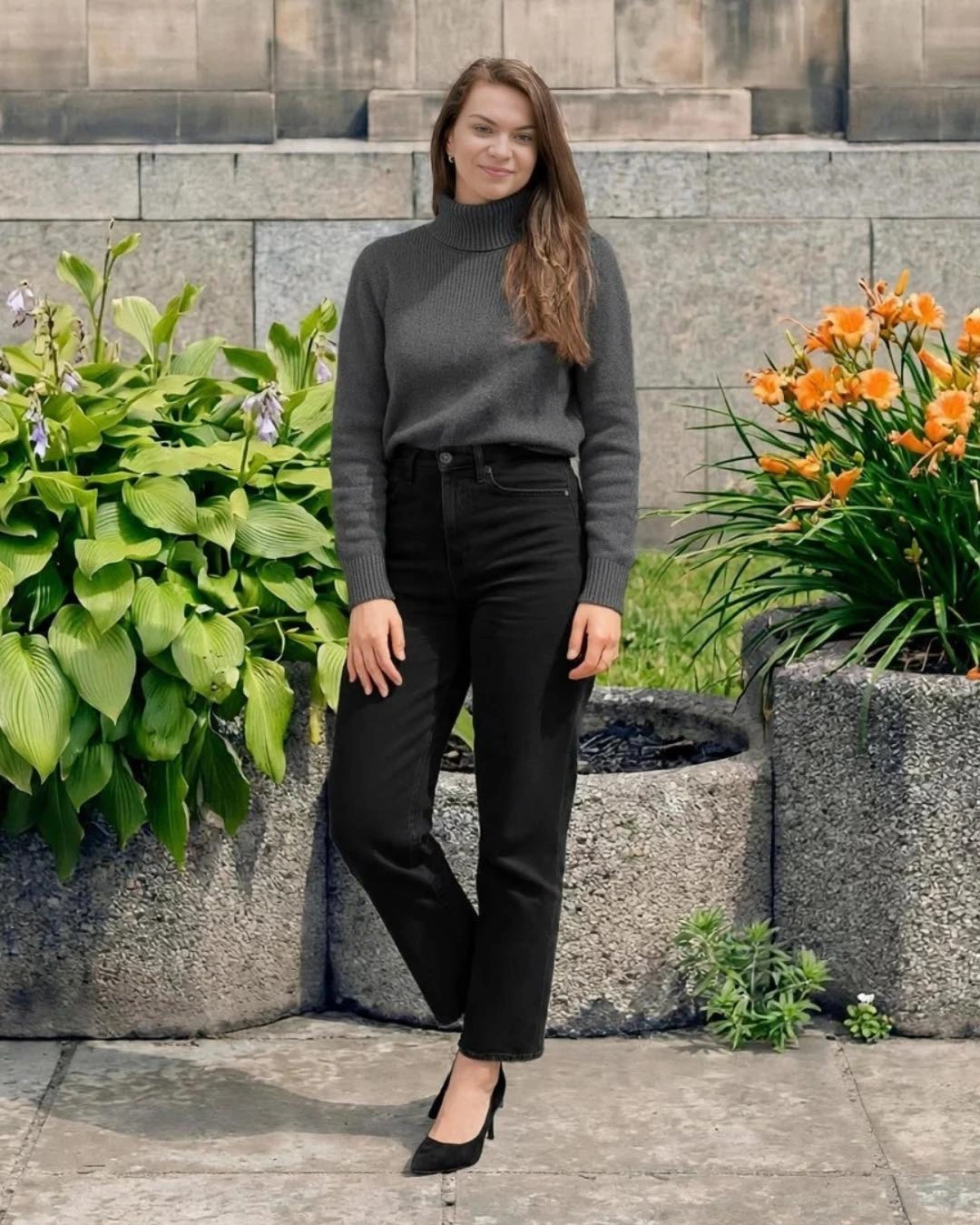 A charcoal turtleneck with black straight-leg jeans and black pumps