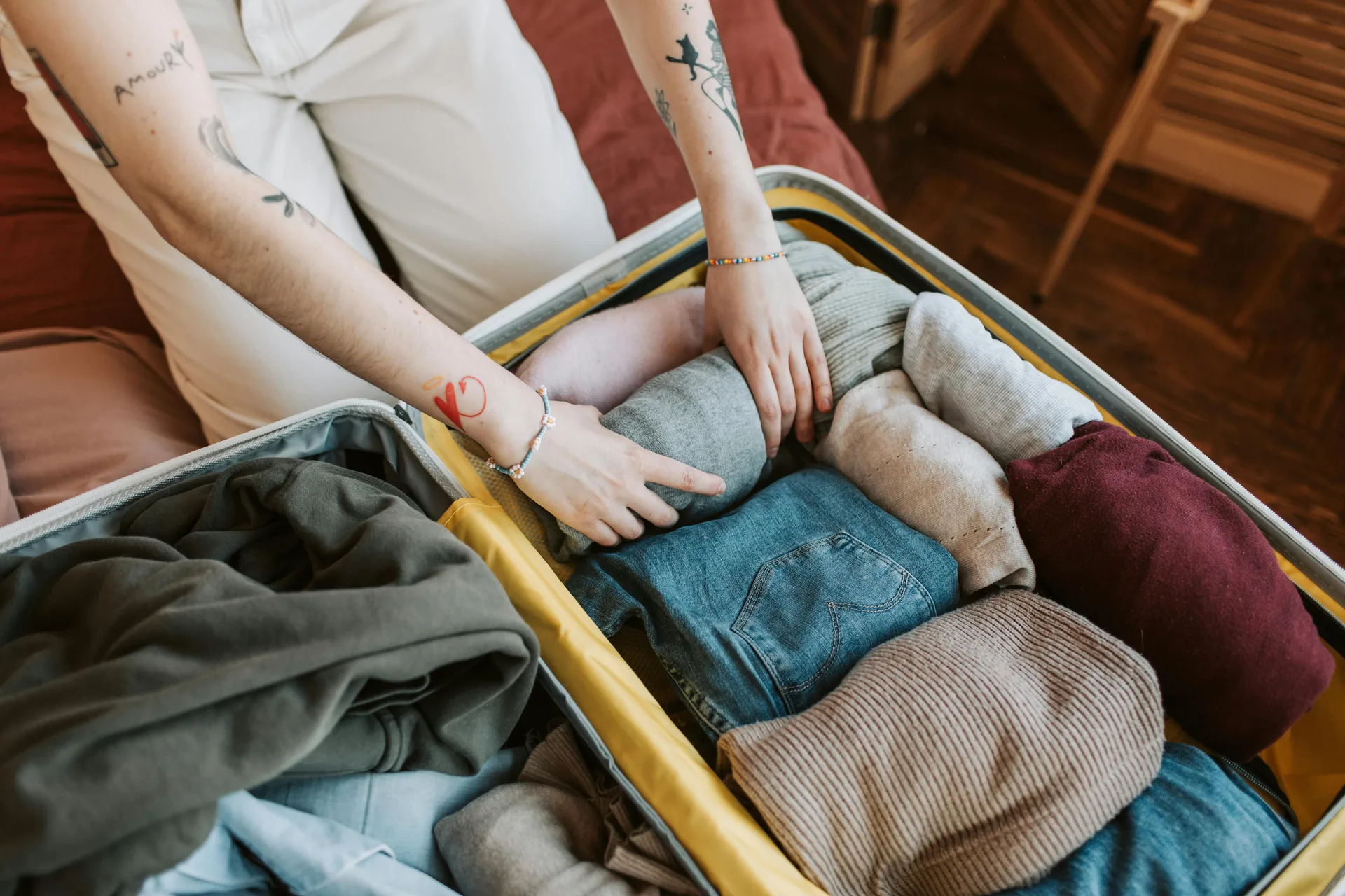 An open suitcase neatly packed with folded clothes