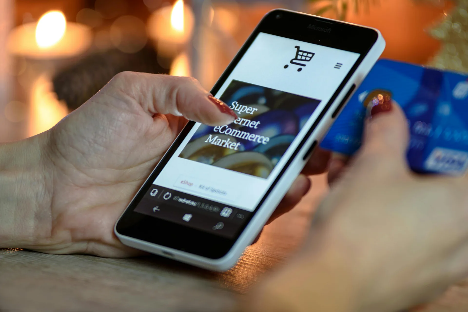 Hands holding a phone open to an online shopping cart