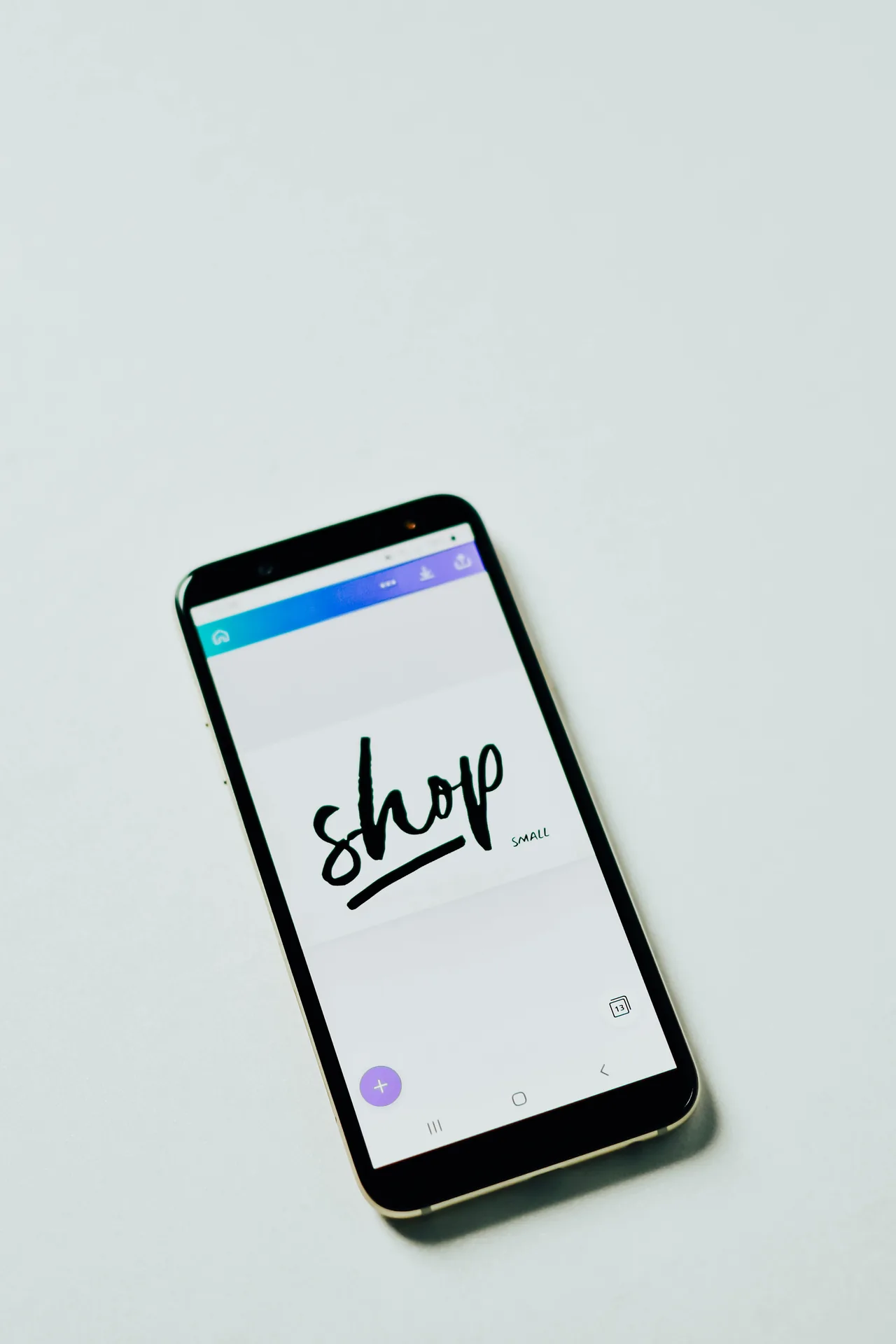 A phone showing a shopping app on a desk