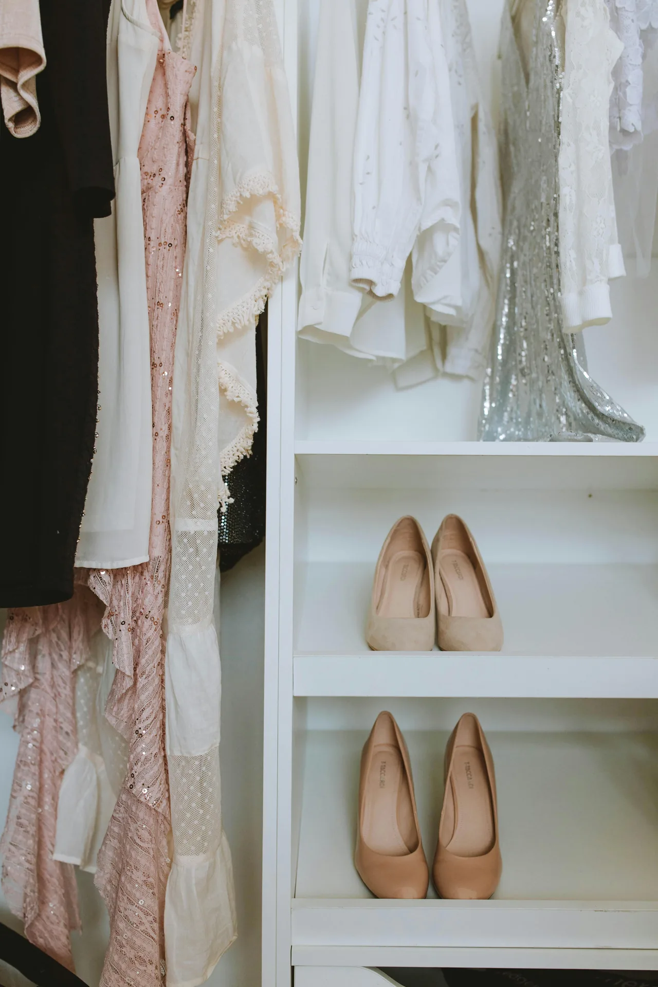 An organized closet with neatly arranged clothes and shoes