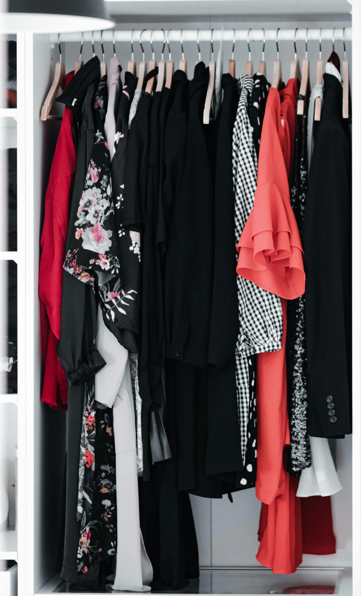 Black, red, and floral pieces hanging together on a rack