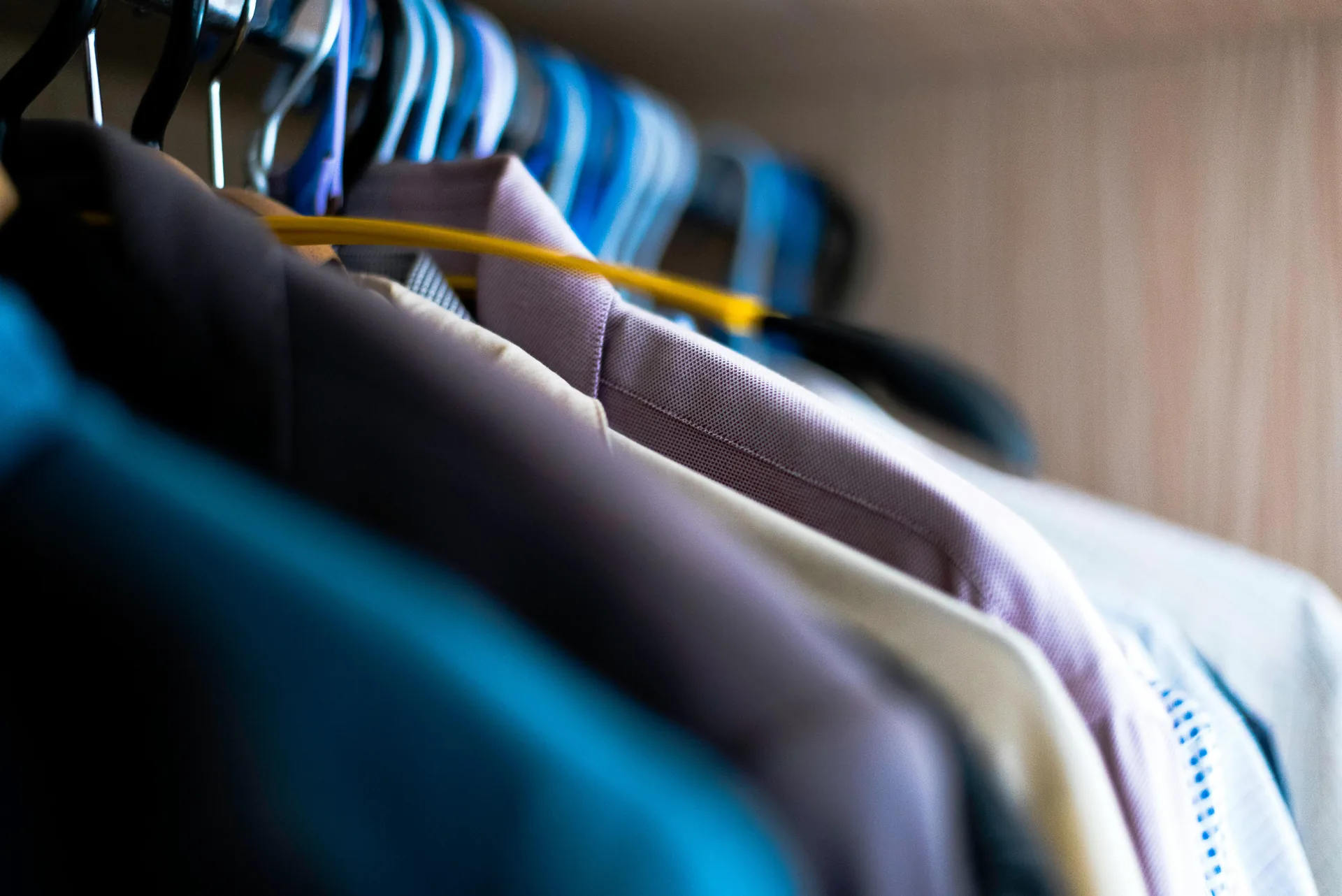 Colorful clothes arranged across a clothing rack
